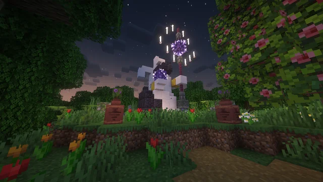 A pale sculptural structure with purple glowing details beside a planted path at night.